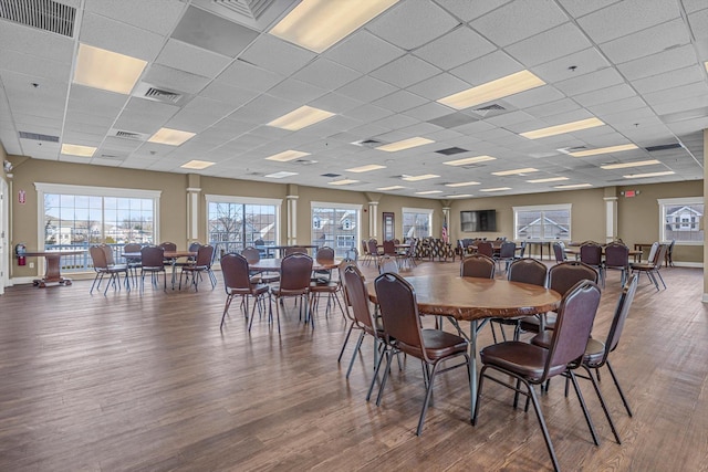 dining room with hardwood / wood-style flooring and a paneled ceiling