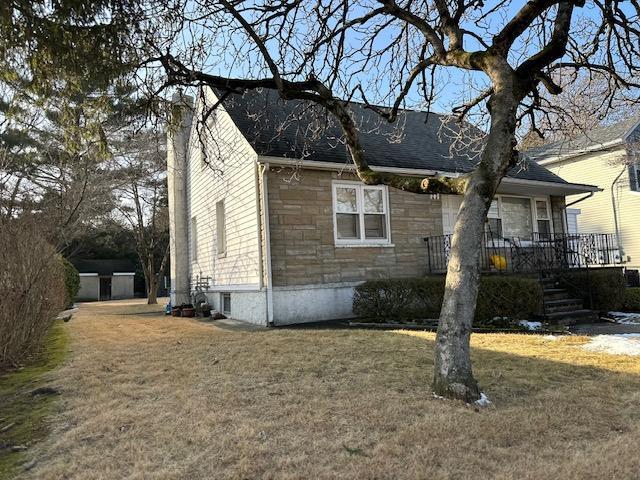 view of side of home featuring a lawn