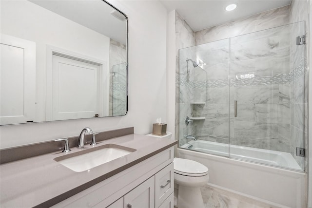 full bathroom featuring vanity, bath / shower combo with glass door, and toilet