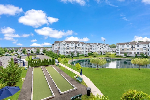 surrounding community featuring a water view and a yard