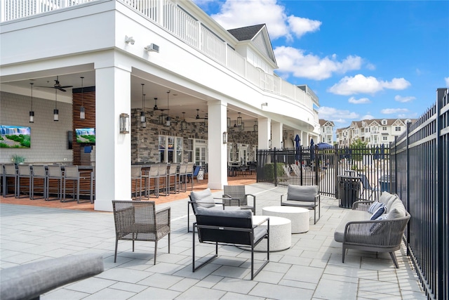 view of patio / terrace featuring a bar and ceiling fan