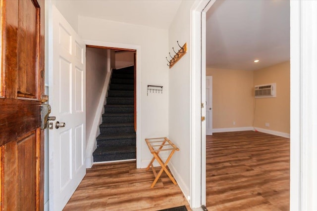 interior space featuring a wall mounted air conditioner and dark hardwood / wood-style flooring