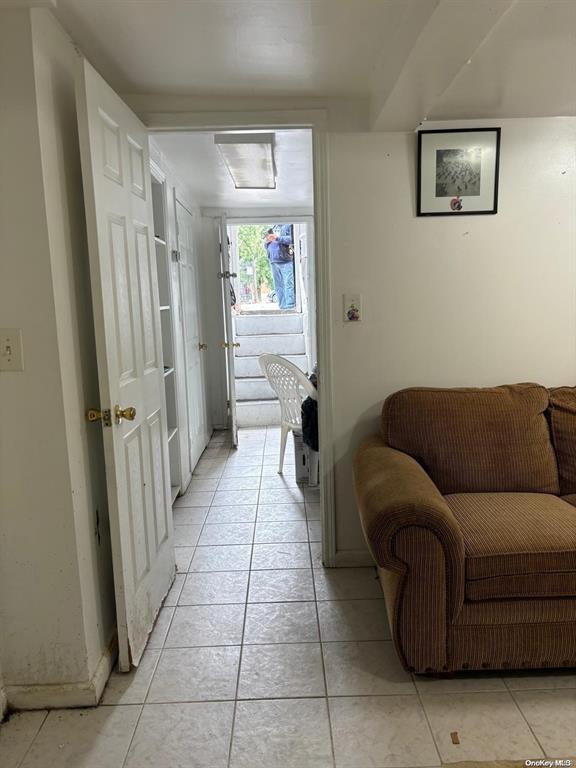 hallway featuring light tile patterned floors