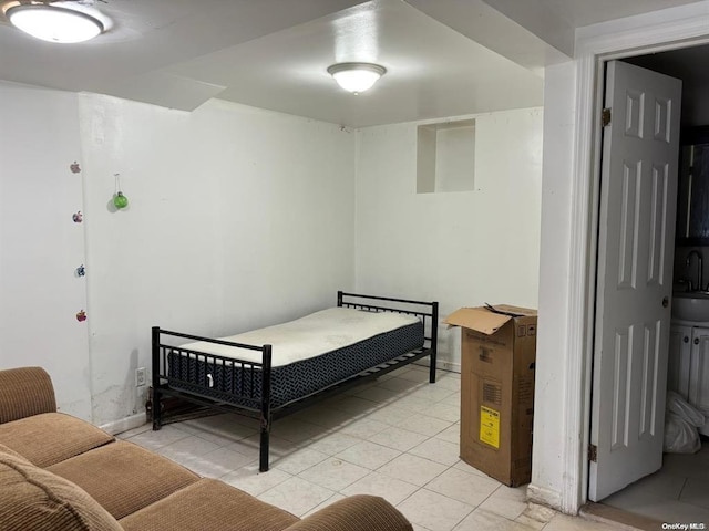 bedroom featuring light tile patterned floors and sink