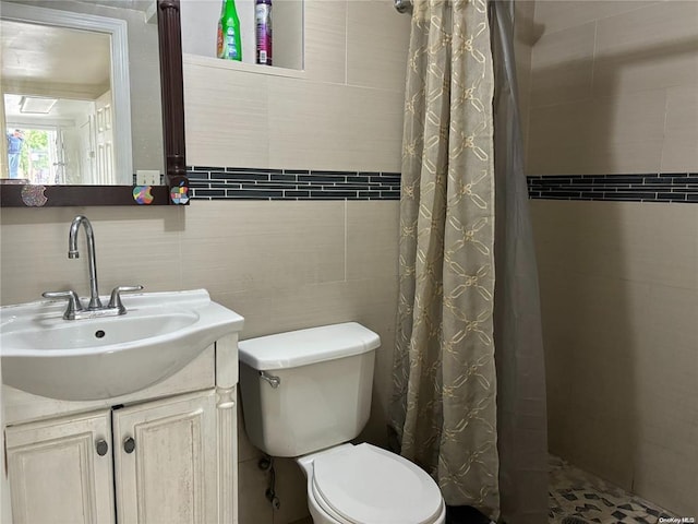 bathroom with vanity, toilet, tile walls, and a shower with curtain