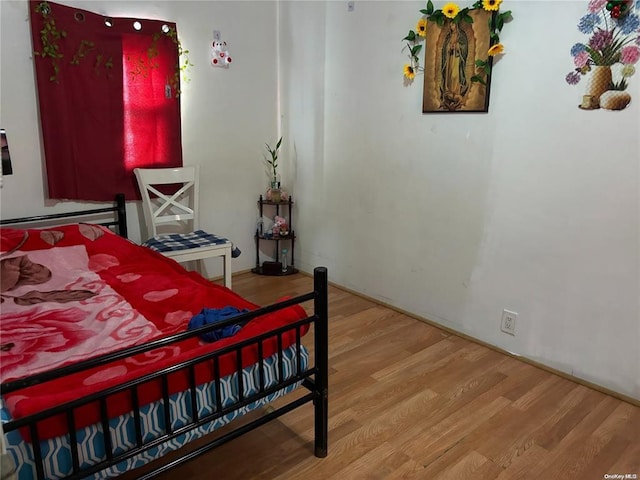 bedroom with wood-type flooring