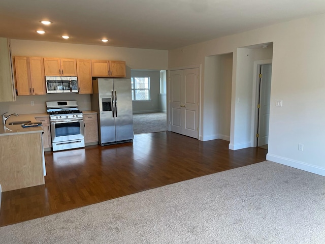 kitchen featuring stainless steel appliances, sink, dark wood-type flooring, and light brown cabinetry