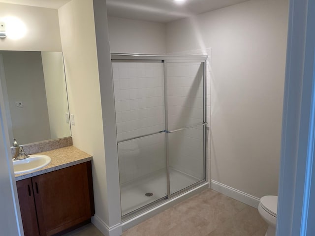 bathroom with vanity, a shower with shower door, and toilet