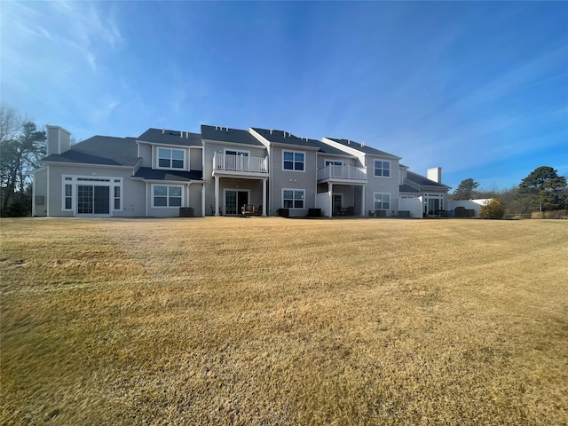 back of property featuring a lawn