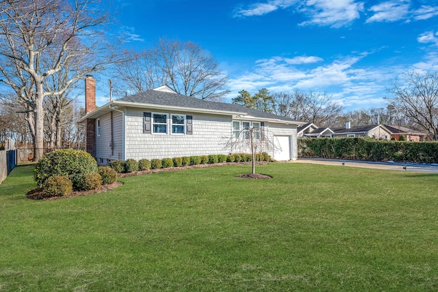 ranch-style home with a garage and a front yard