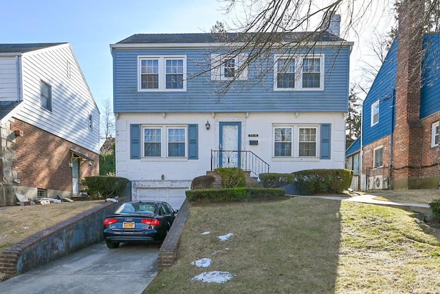 view of front of house with a garage and a front yard