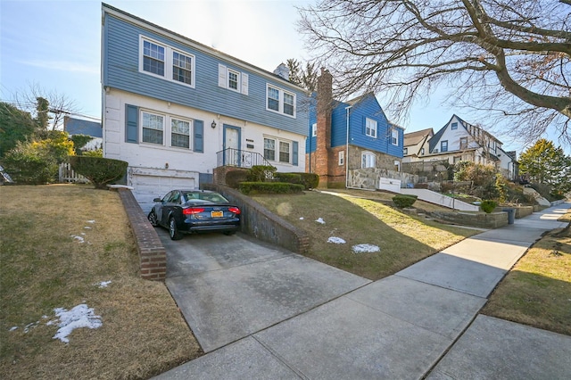 view of front of house featuring a garage and a front lawn