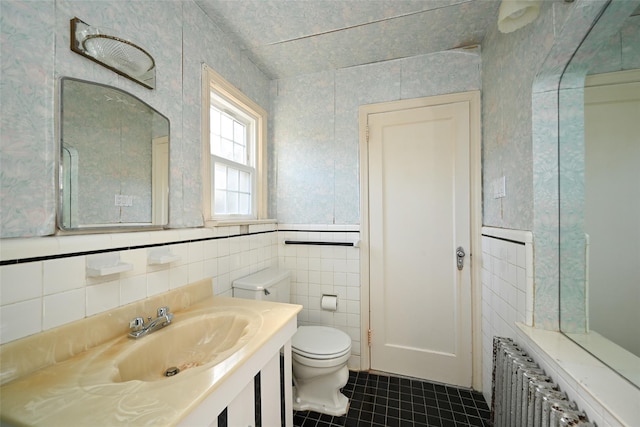 bathroom featuring radiator, tile walls, tile patterned flooring, vanity, and toilet