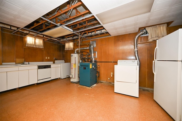 basement featuring washer / clothes dryer, gas water heater, wood walls, and white refrigerator