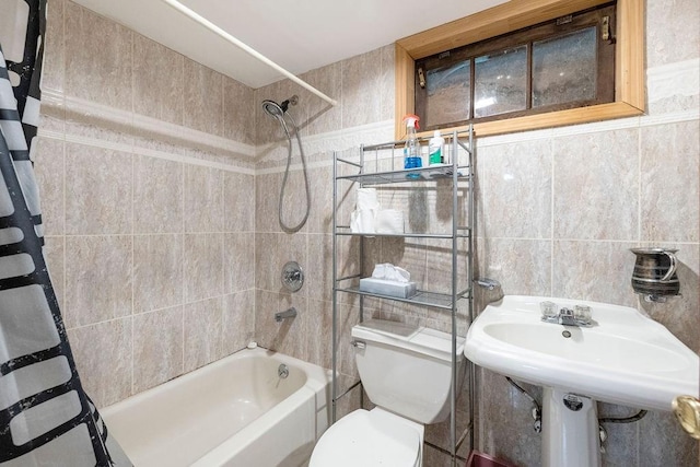 full bathroom with shower / tub combo with curtain, toilet, sink, and tile walls