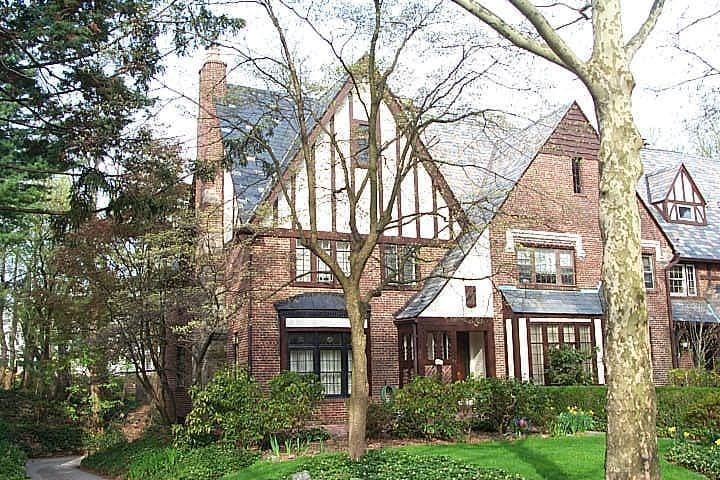 english style home with a front lawn