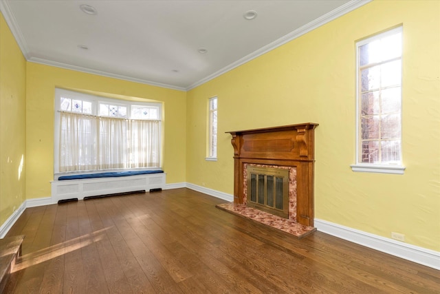 unfurnished living room featuring crown molding, dark wood-type flooring, and a wealth of natural light