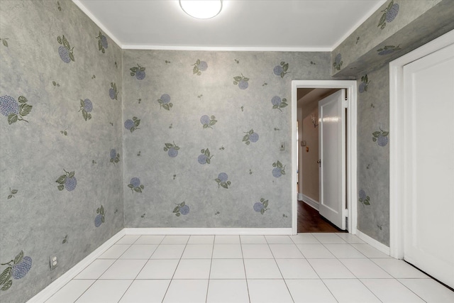 empty room with ornamental molding and light tile patterned flooring