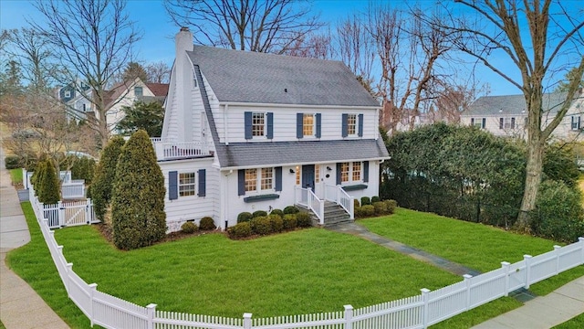 view of front facade featuring a fenced backyard, a chimney, roof with shingles, a gate, and a front yard