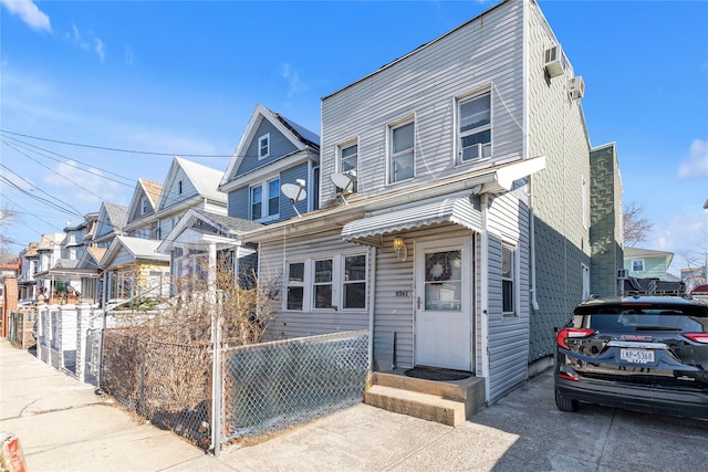 view of front of house featuring a residential view and fence