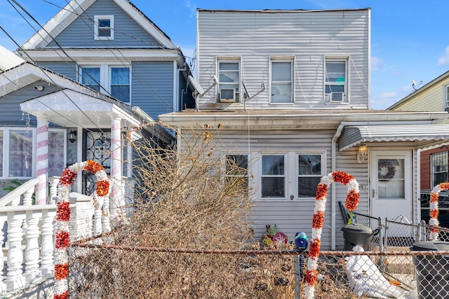 view of front of home with cooling unit and fence