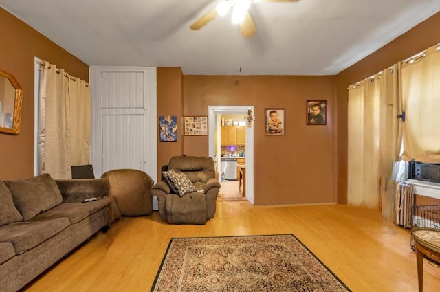 living area featuring a ceiling fan and wood finished floors