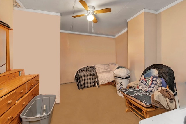 carpeted bedroom featuring ceiling fan and crown molding