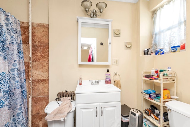 bathroom with toilet, curtained shower, and vanity