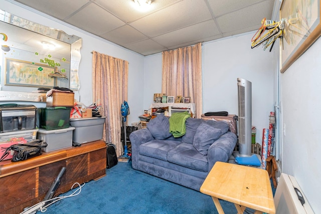 sitting room featuring carpet and a drop ceiling