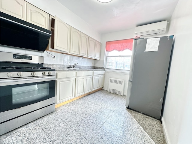 kitchen with sink, backsplash, radiator heating unit, stainless steel appliances, and a wall mounted air conditioner