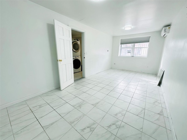 unfurnished room featuring stacked washer / drying machine and a wall mounted air conditioner