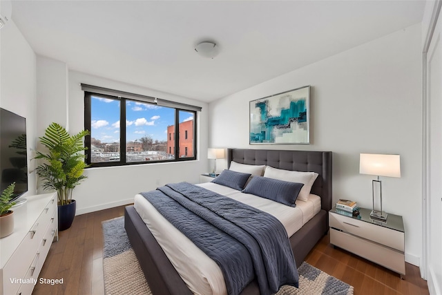 bedroom with dark wood-type flooring