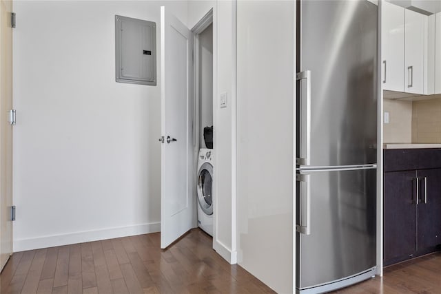 washroom featuring dark hardwood / wood-style floors, electric panel, and washer / dryer