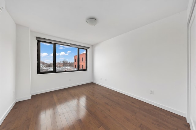 spare room featuring dark hardwood / wood-style flooring