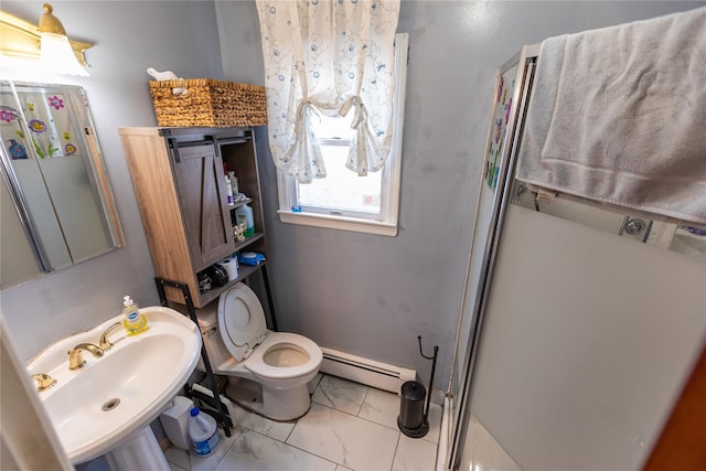 bathroom with a shower with shower door, a baseboard heating unit, sink, and toilet