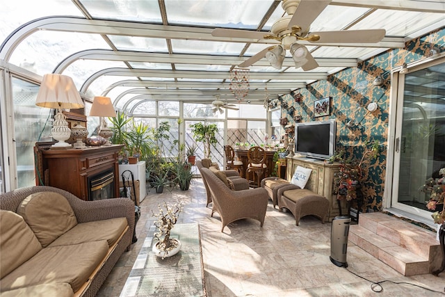 sunroom / solarium featuring ceiling fan