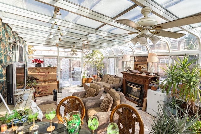 sunroom featuring ceiling fan and a wealth of natural light