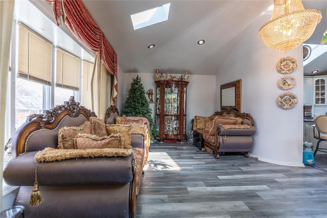 interior space with a notable chandelier, hardwood / wood-style flooring, a skylight, and high vaulted ceiling