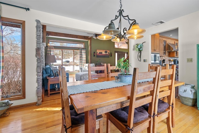 dining room featuring a chandelier and light hardwood / wood-style flooring