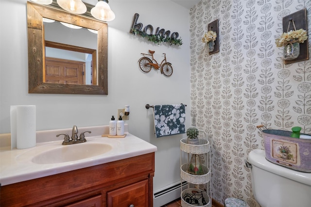 bathroom with vanity, a baseboard radiator, and toilet