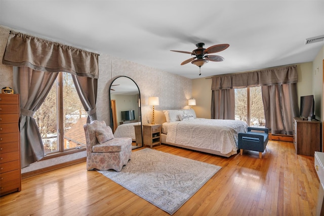 bedroom with ceiling fan and light hardwood / wood-style floors