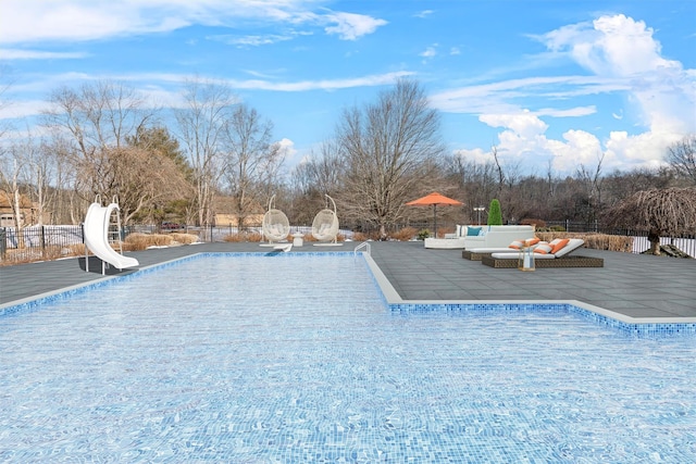 view of pool with a patio and a water slide