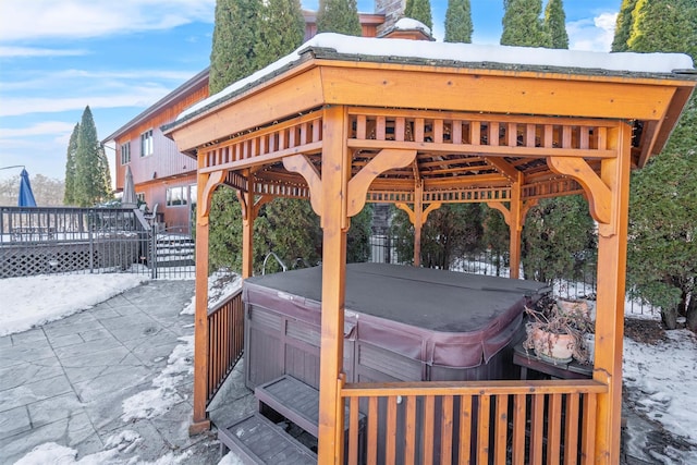 view of patio with a wooden deck and a hot tub