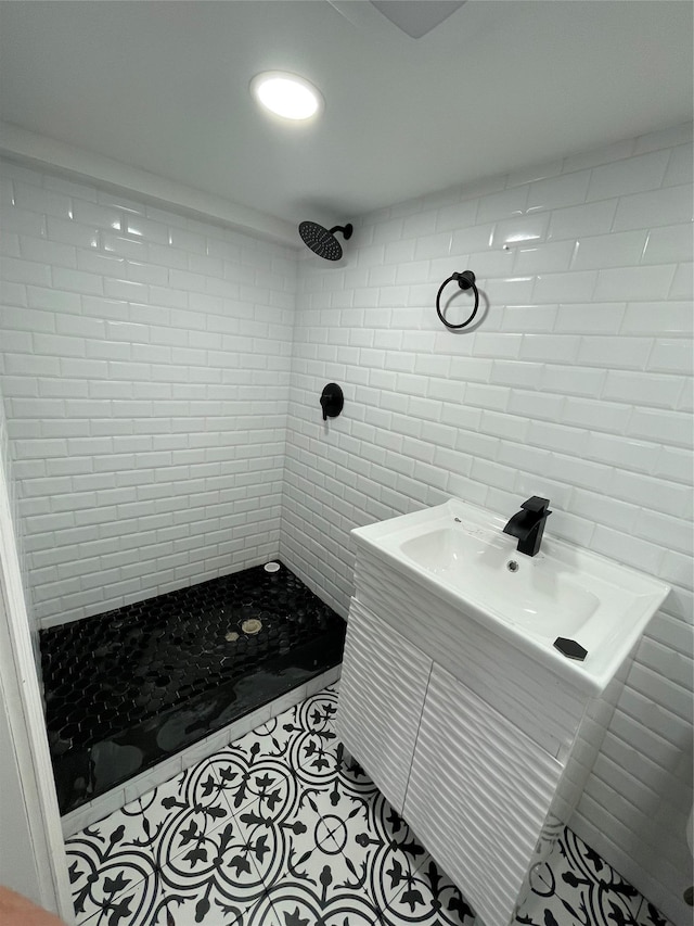 bathroom featuring tile patterned flooring and tiled shower