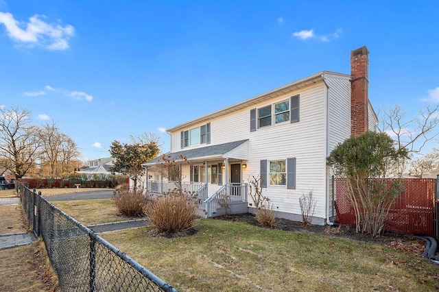 view of front of house featuring covered porch and a front yard