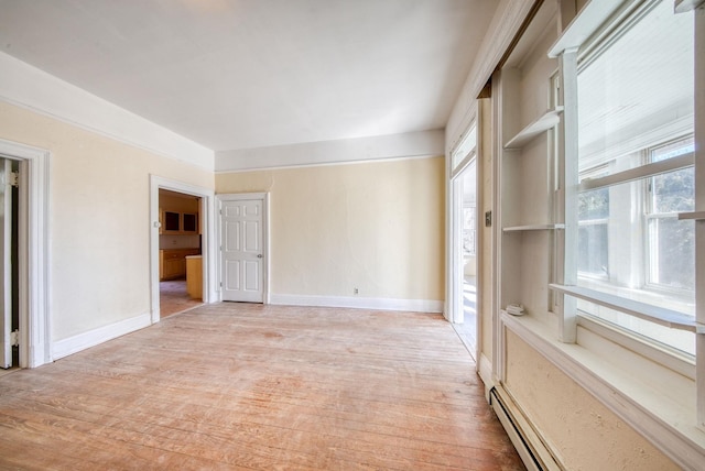 spare room with light wood finished floors and baseboards