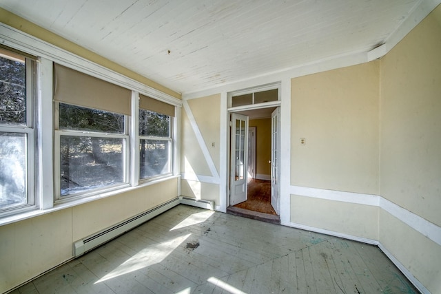 unfurnished room featuring a baseboard heating unit