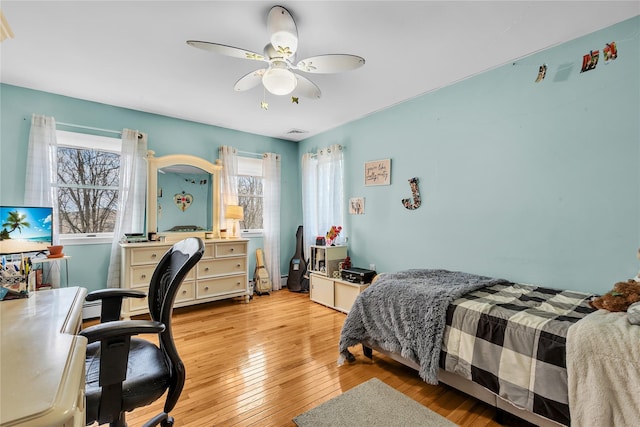 bedroom with ceiling fan and light hardwood / wood-style flooring