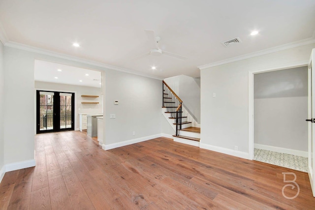 interior space with crown molding, ceiling fan, light hardwood / wood-style floors, and french doors