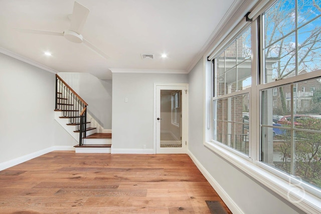 unfurnished room featuring light hardwood / wood-style flooring, ornamental molding, and ceiling fan